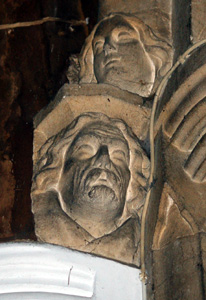 Heads on the chancel arch north side May 2010